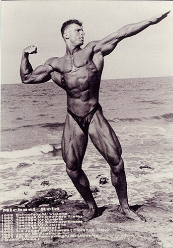 Staff Member - Michael Reid - Body building pose on a beach (P3642)