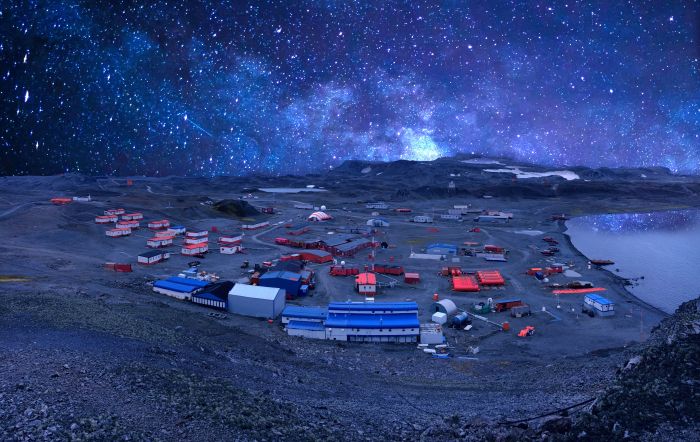 An illustration showing an outpost of scattered buildings on a lunar surface, against a horizon of hundreds of stars.