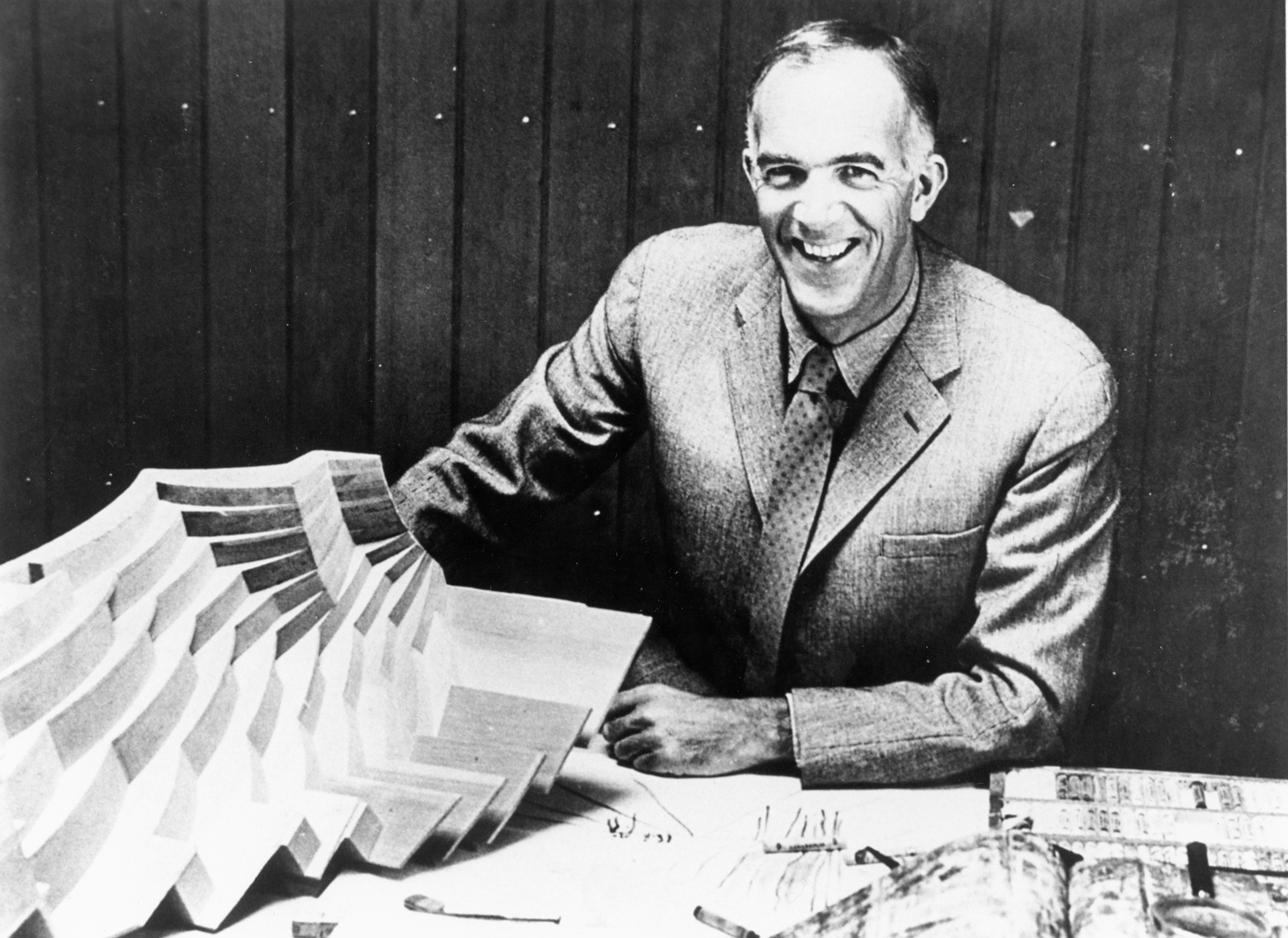 black and whilte photo of Jørn Utzon holding a model representing part of the internal structure of the Sydney Opera House