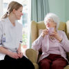 young nurse chatting with senior woman in care home