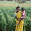 Mother and child in front of crops