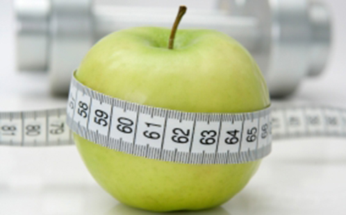 Tape measure wrapped around apple
