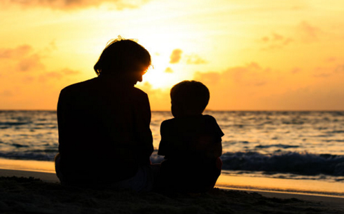 Child and parent at sunset