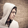 Disenchanted teenage boy wearing a hooded top