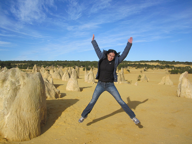 HDR student jen li dressed in jeans jumping in the air