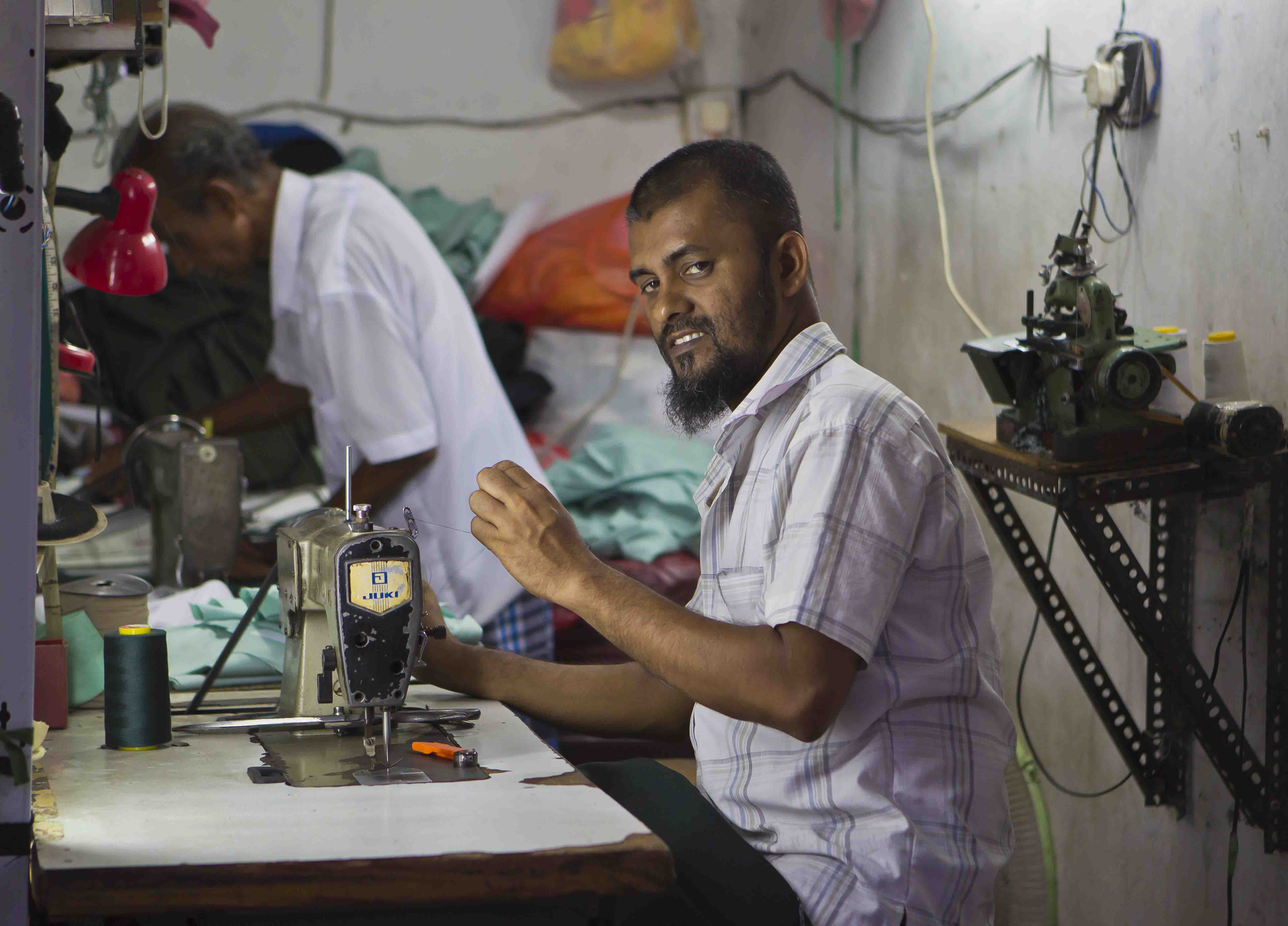 A man using a sewing machine 