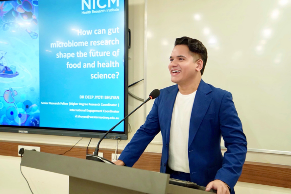 Dr Deep Chuyan presenting his research at a lectern