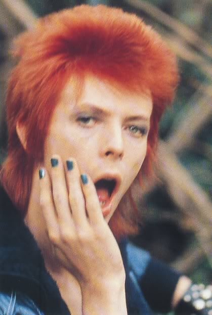 Red headed Bowie with painted nails and mouth open