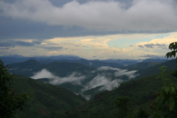 Looking down over tree-covered hills in Laos.