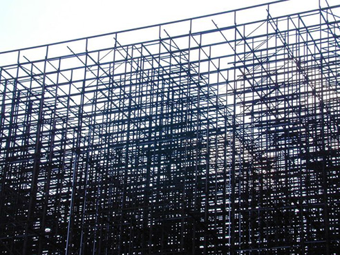 Layer of scaffolding with a white sky behind it. Image thanks to sevensixfive.