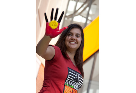 Student with aboriginal flag hand painting (Image courtesy of UWS iMedia)
