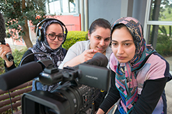 Female students using a commercial video camera