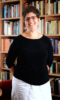 portrait photograph of a woman with short hair and glasses