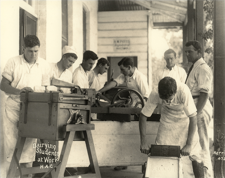 Dairy Factory (exterior): A posed photo of dairy students making butter under supervision on verandah of dairy factory [Hawkesbury Agricultural College (HAC)]