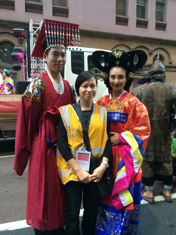 Alex standing with a male and female Chinese New Year participants