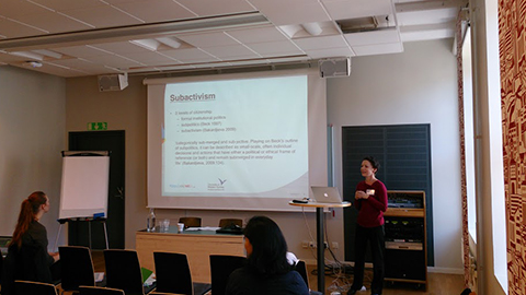 Cecilia Hilder presenting a paper at a conference.