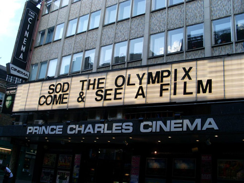 Prince Charles Cinema from the outside. The lit sign reads 'Sod the Olympics come & see a film'.
