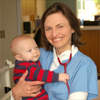 A nurse holding a baby 