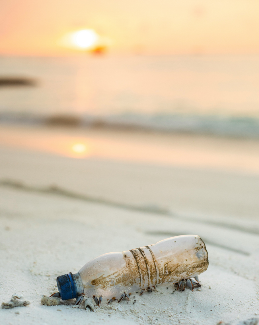 A plastic bottle, discarded at the beach