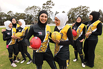 Young muslim women holding soccer balls