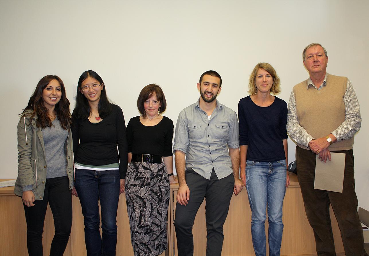 3MT participants standing in front of a white wall