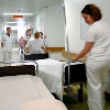 Nurses pulling a sickbed in a hospital