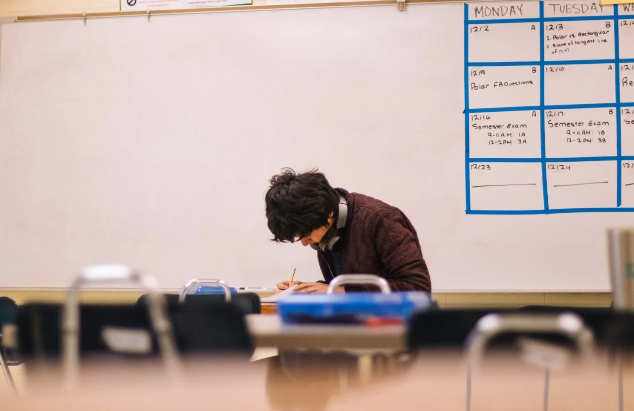 School teacher alone in clsasroom