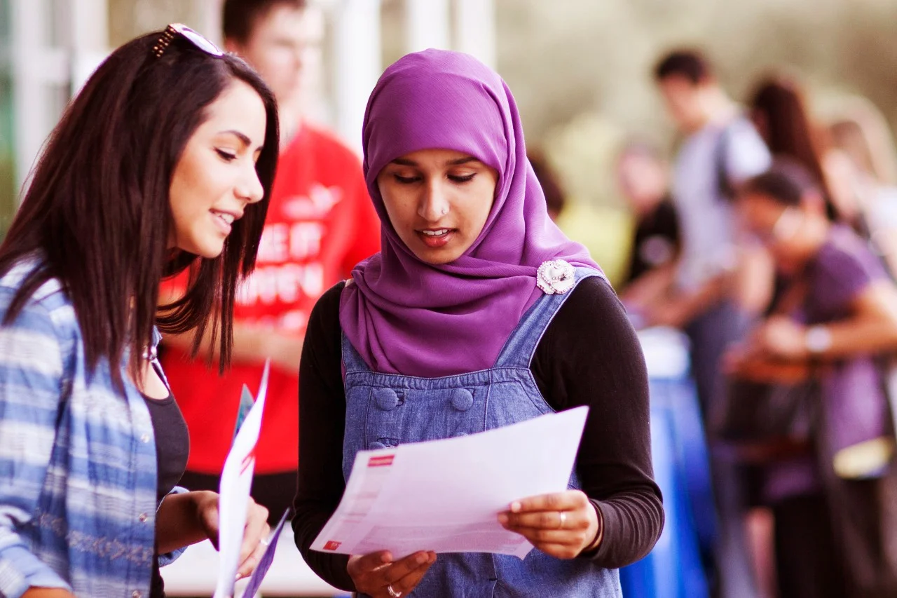 Student assisting another student on campus