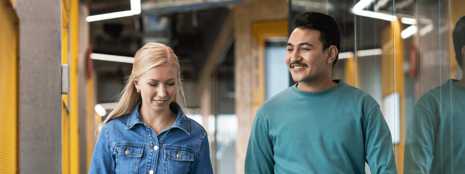 A female and male student are walking together on campus
