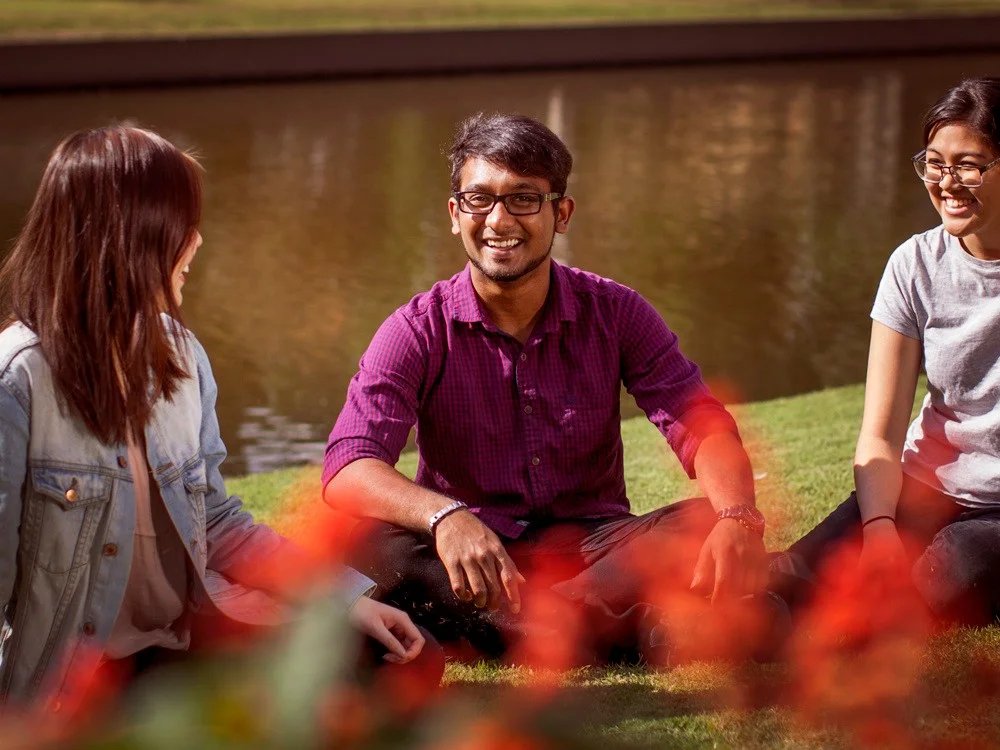 Students sitting in a park