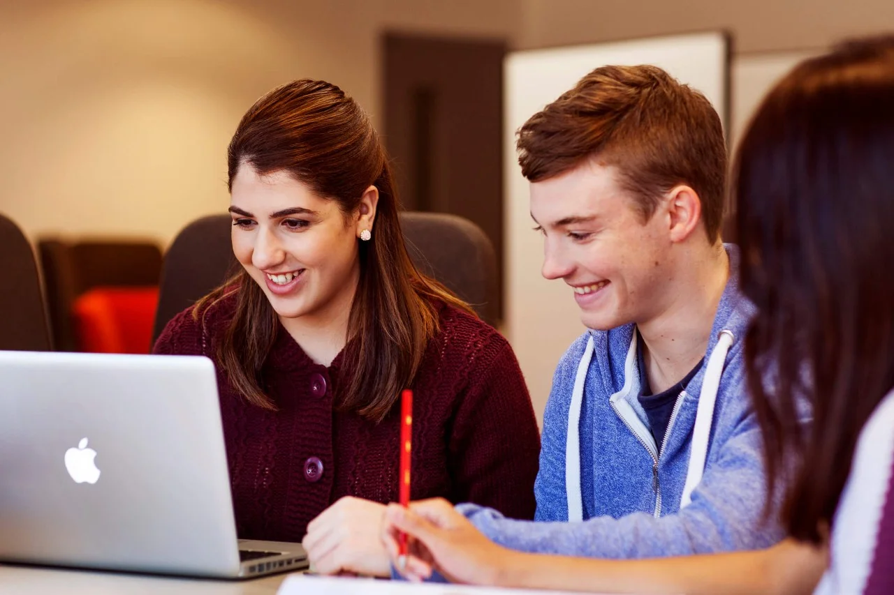 Three students with computer