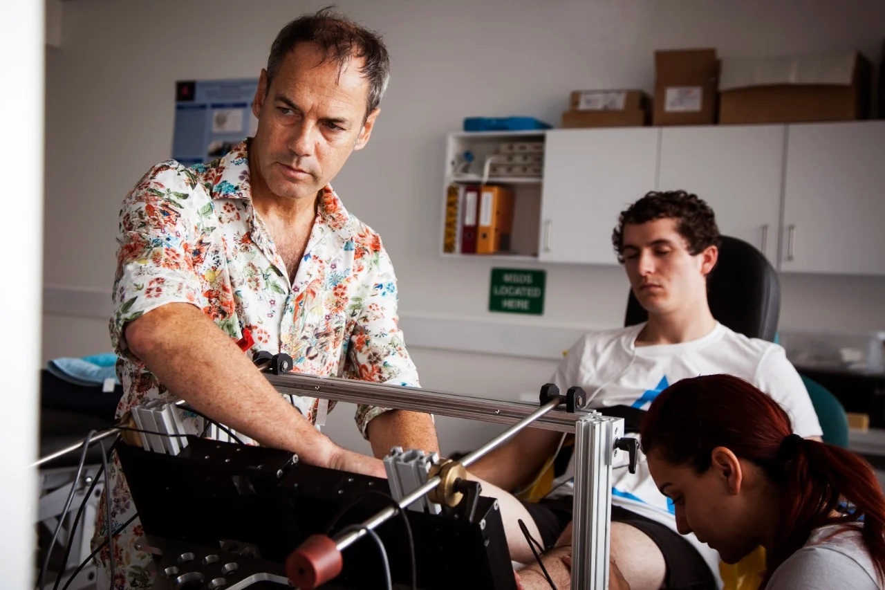 Male physician providing individualised support to male patient in chair