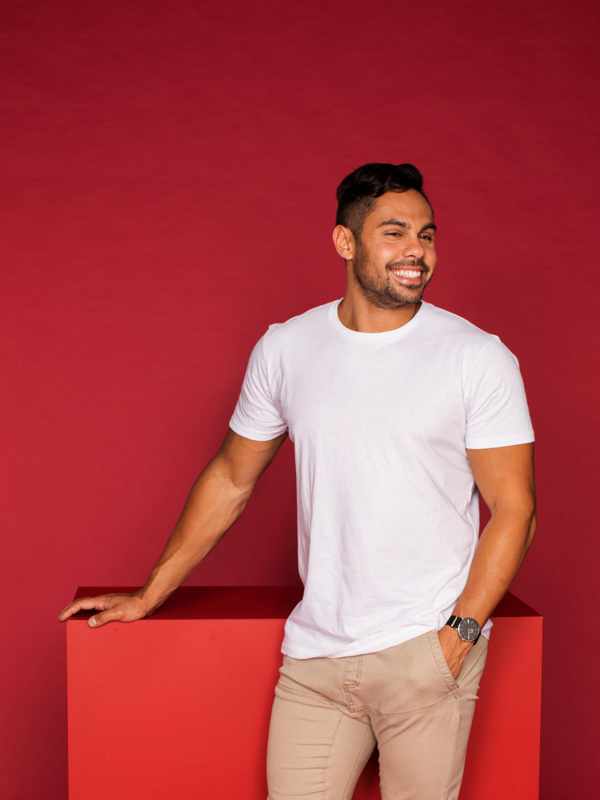 Student smiling with crimson background