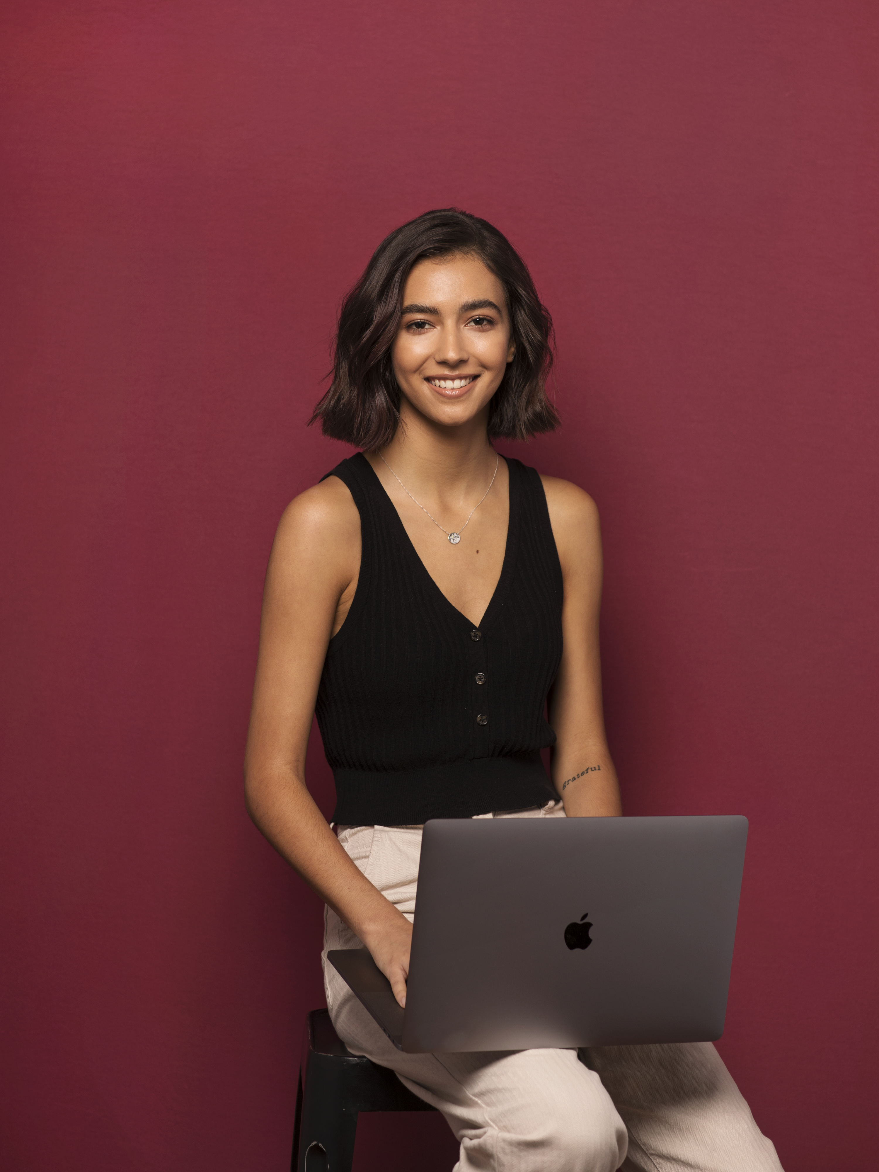 Student smiling with crimson background