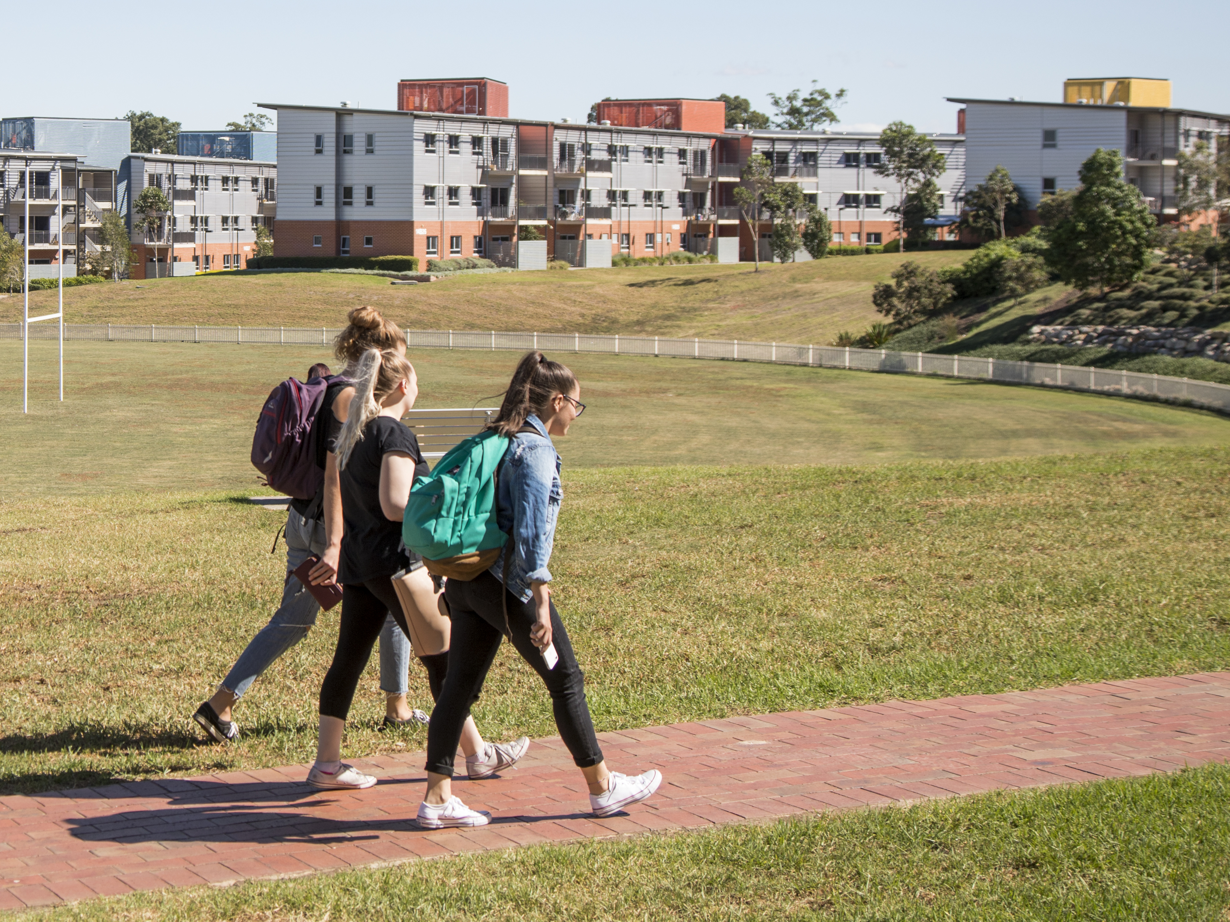Three students walking around campus