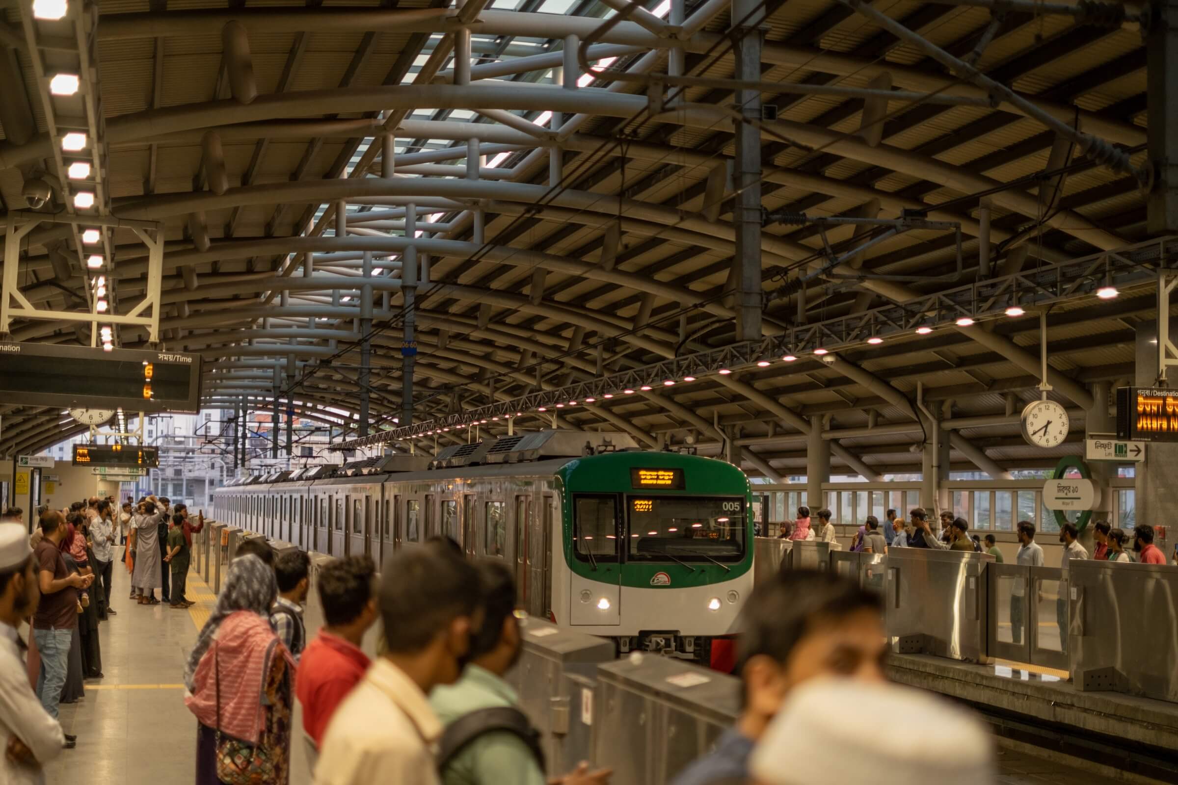 A group of people waiting at a metro station in Dhaka City, Bangladesh