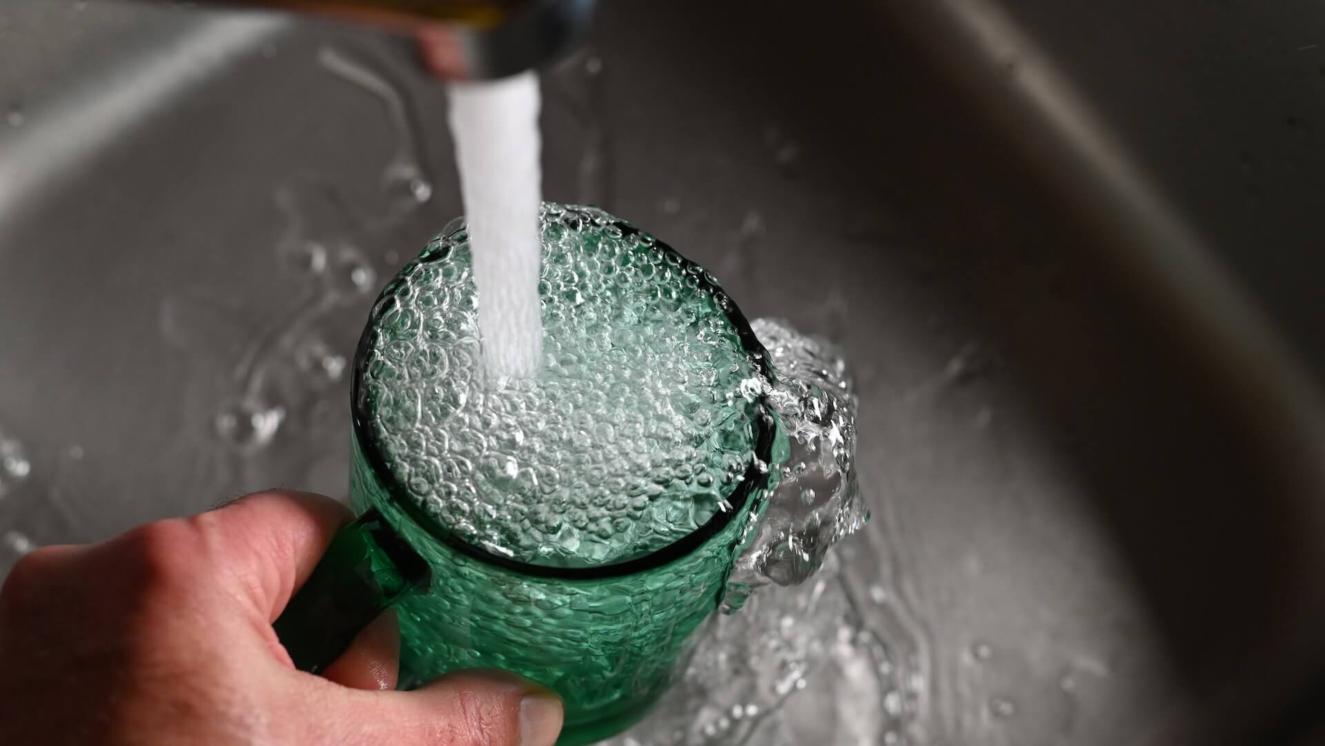 Tap water filling a glass