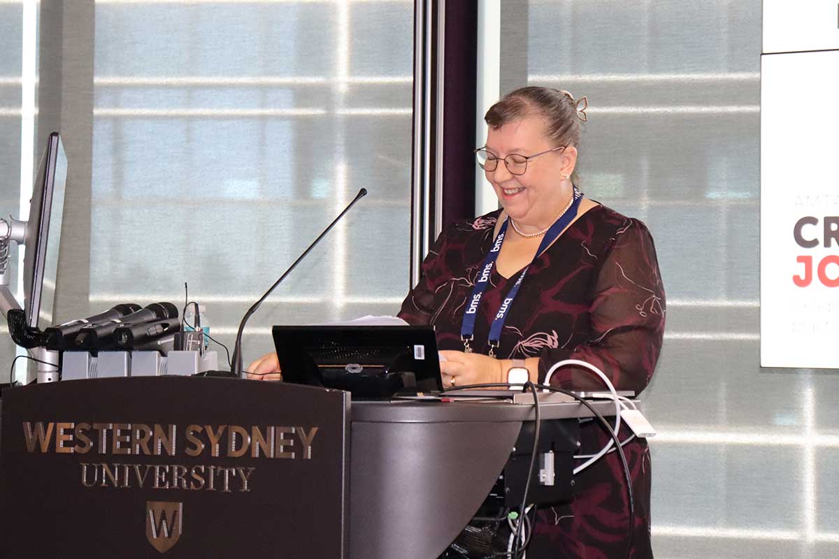 female lecturer standing in front of podium