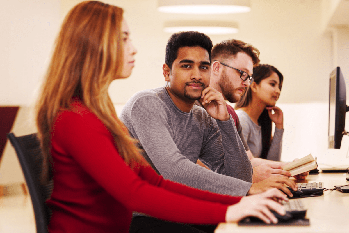 Four students are seen working in a computer lab