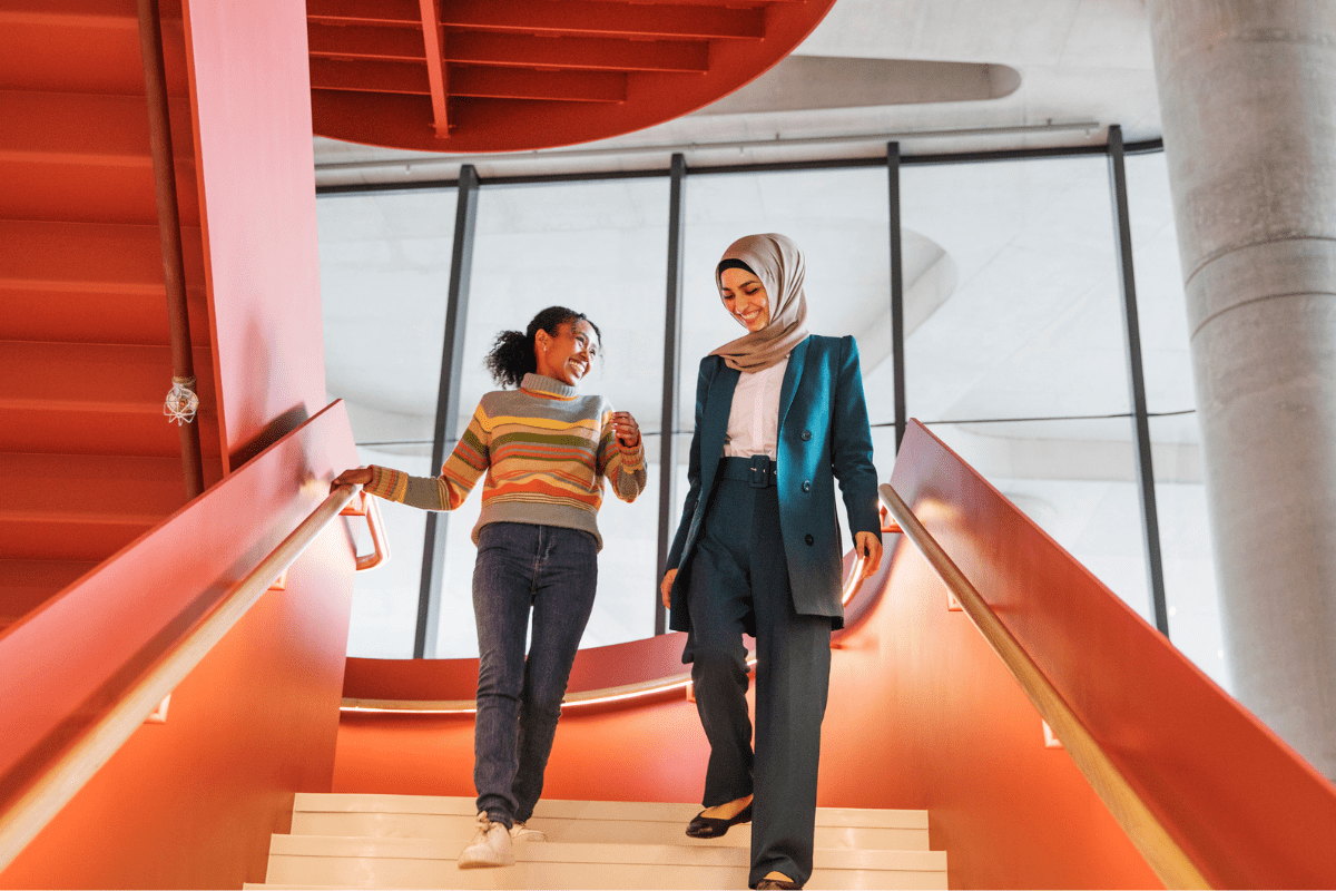 Two female students walking down the stairs