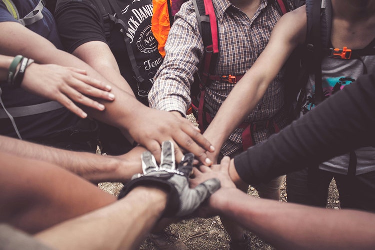 Group joining hands in unity