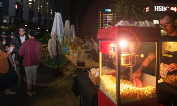 Night outdoor event with popcorn stand