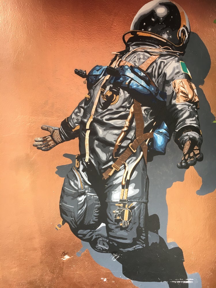 An illustration of an astronaut opening their arms towards a bright light to their right.