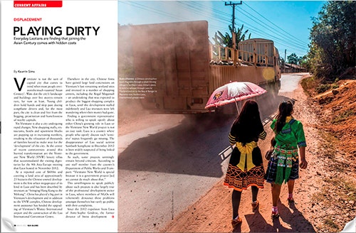 The first spread of Kearrin Sims' article in Globe magazine. Includes a photo of a Chinese construction truck driving through a small village in Laos.