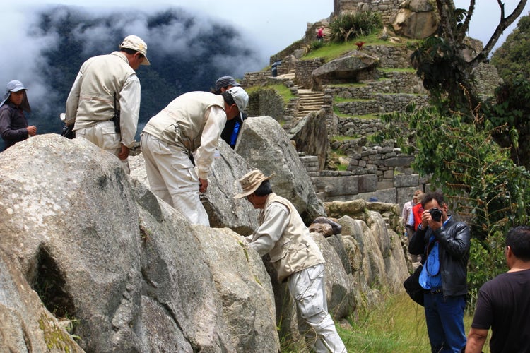 Conservation staff inspecting stonework in Machu Picchu
