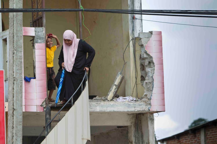 Woman wearing pink hijab with young boy