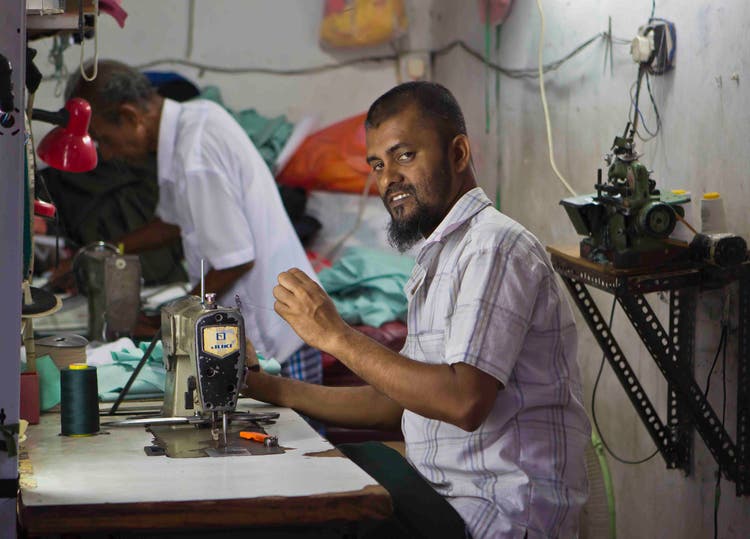 A man using a sewing machine