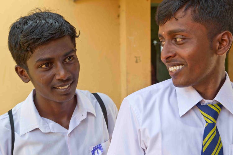 Two young men wearing school uniform