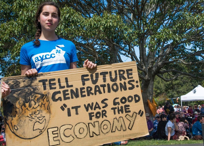 Young girl holding cardboard placard
