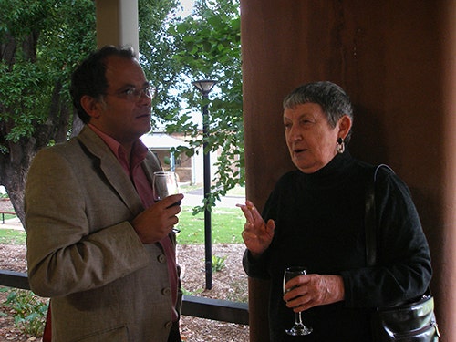 Sandro Mezzadra and Jeannie Martin standing and talking outside building EM.